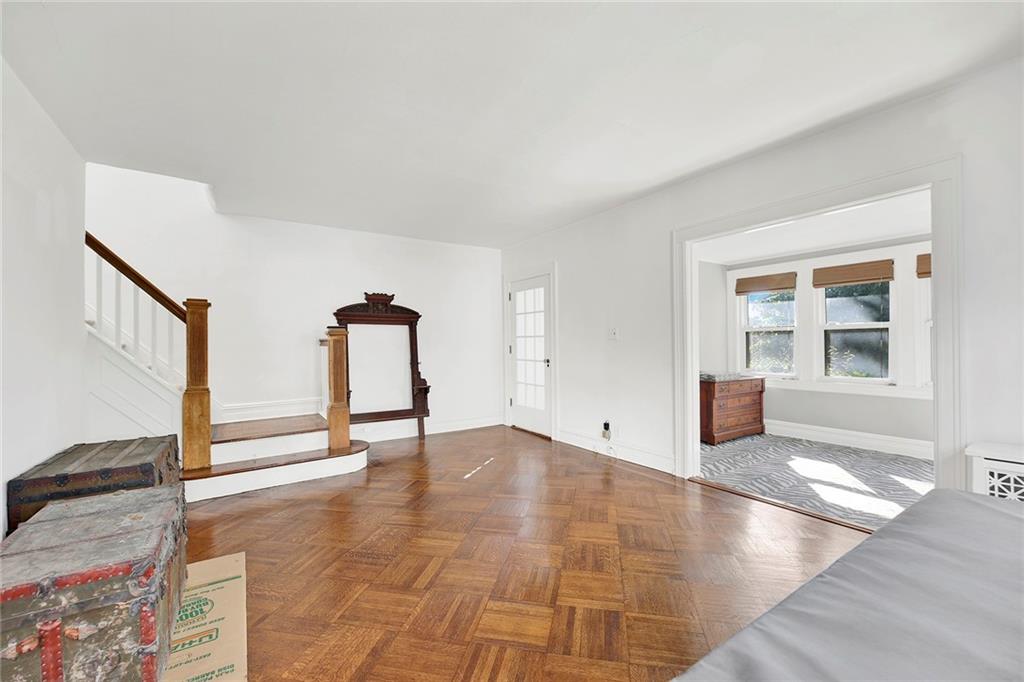 2991 Quentin Road Brooklyn, NY 11229 - Photo 7 of 30 a view of an empty room with wooden floor and a window