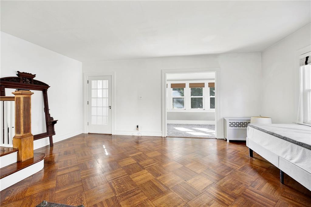 2991 Quentin Road Brooklyn, NY 11229 - Photo 9 of 30 a view of empty room with wooden floor and fan