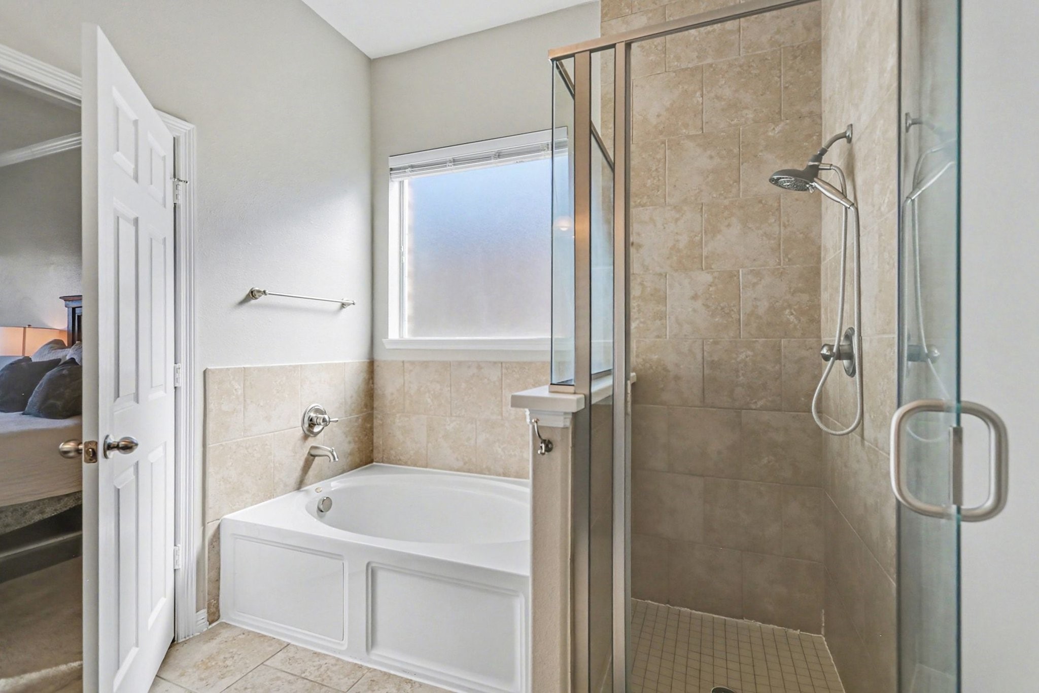 27006 Cliff Pointe Lane Katy, TX 77494 - Photo 23 of 34 Relax and recharge in the primary bathroom with a soaking tub, separate walk-in shower, and tile surround—both practical and retreat-worthy.