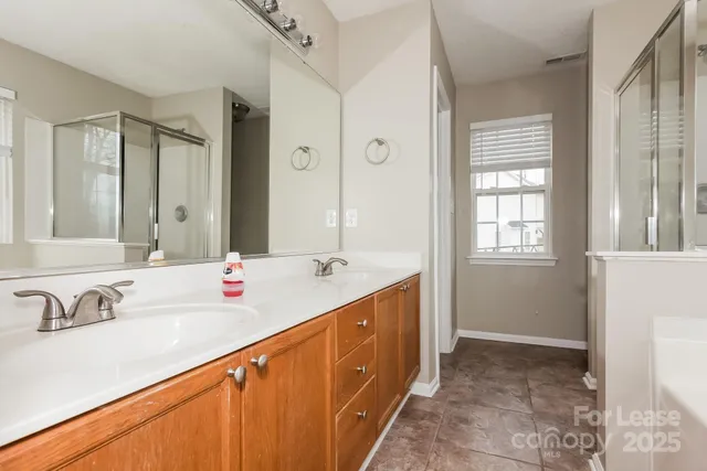 a spacious bathroom with a double vanity sink and a mirror