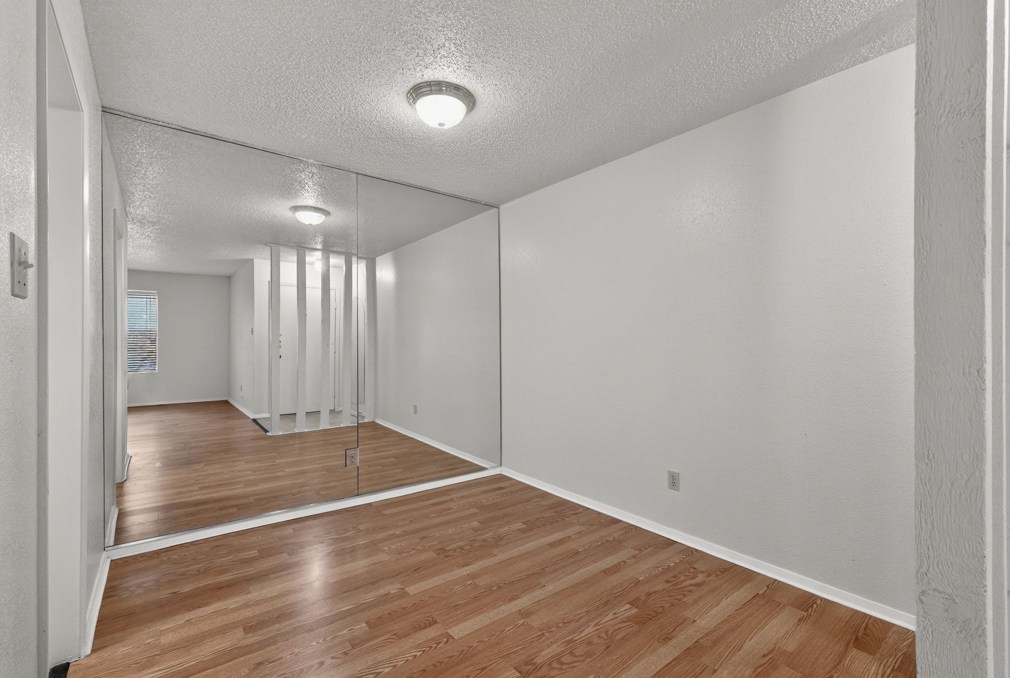 8210 Bent Tree Road, Unit 256 Austin, TX 78759 - Photo 8 of 29 a view of an empty room with wooden floor