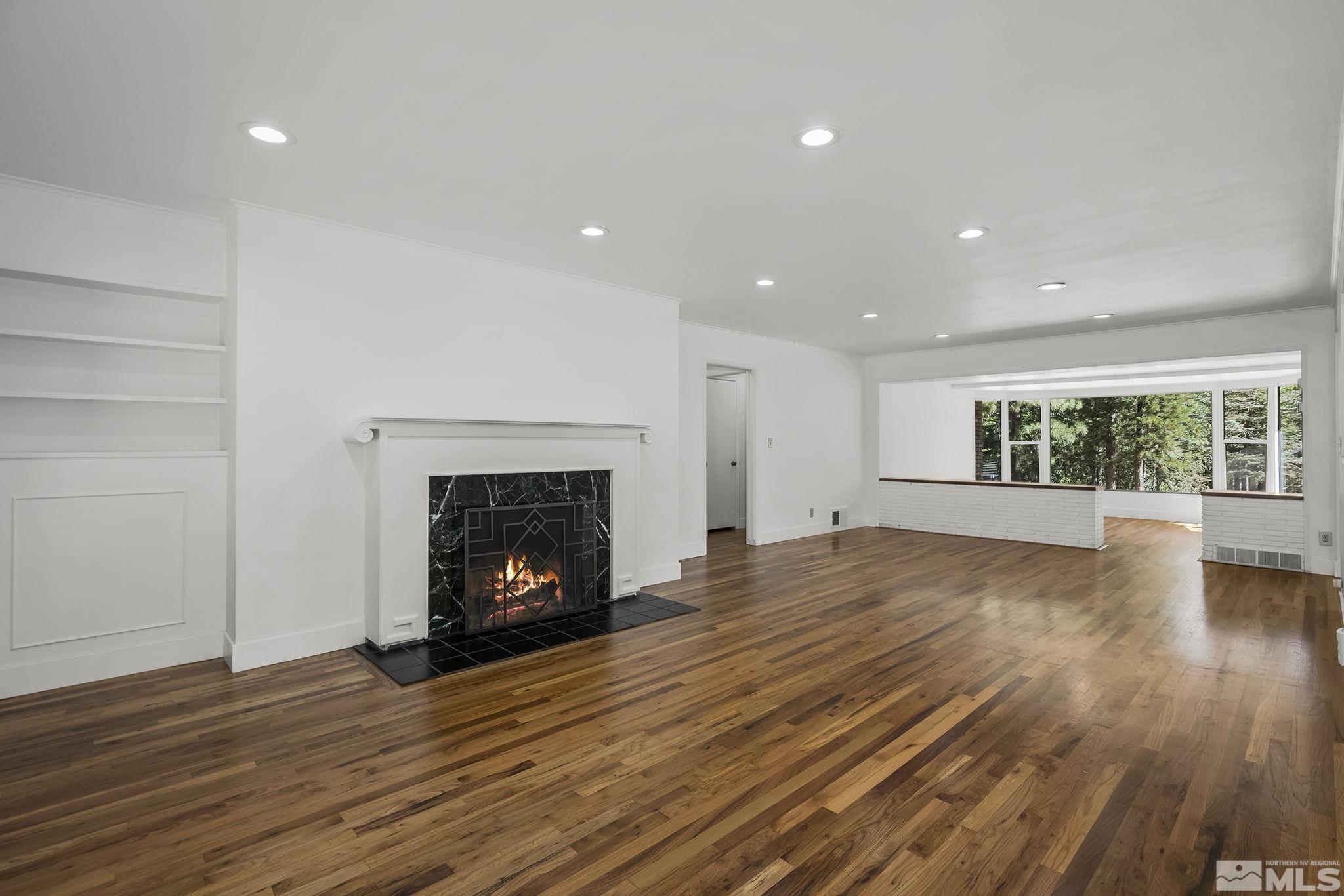 13 Rancho Manor Drive Reno, NV 89509 - Photo 3 of 40 a view of an empty room with wooden floor fireplace and a window