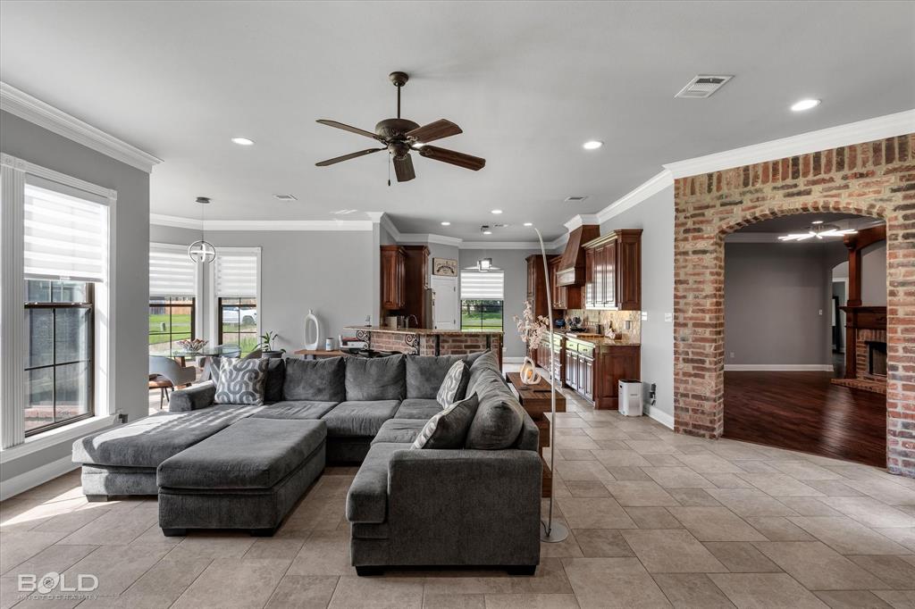 2220 Forest Hills Boulevard Haughton, LA 71037 - Photo 22 of 40 Spacious open-concept interior featuring light tile flooring and a brick archway