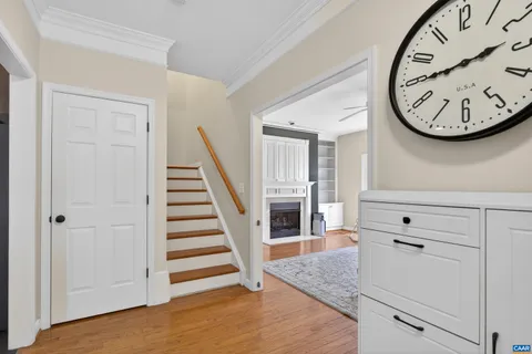 a view of a hallway with entryway wooden floor and front door