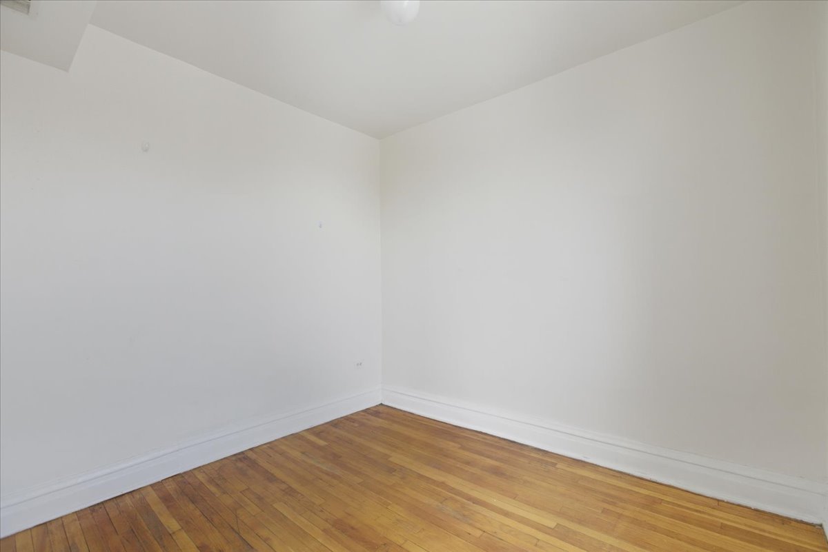 3133 West Augusta Boulevard, Unit 3E Chicago, IL 60622 - Photo 10 of 10 a view of an empty room with wooden floor