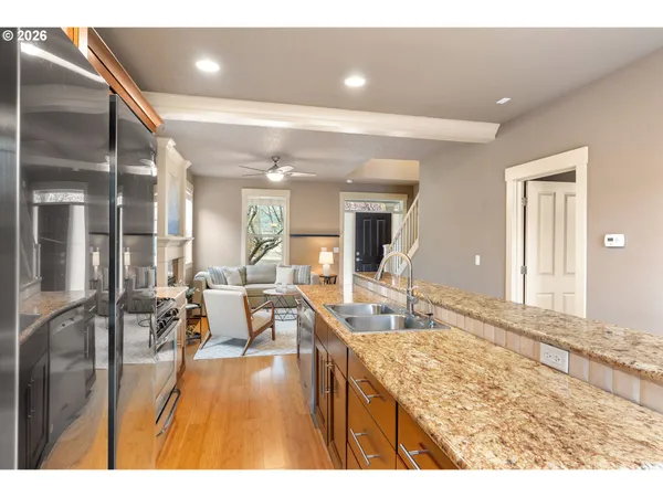 a living room with kitchen island granite countertop furniture and a large window