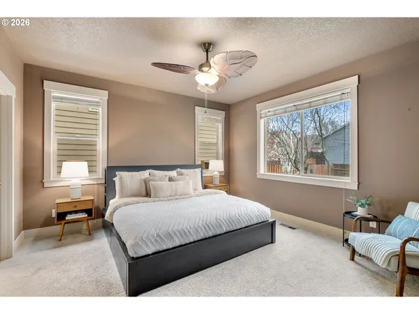 a bedroom with a large bed and a chandelier