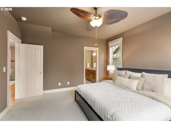 a bedroom with a large bed and a chandelier
