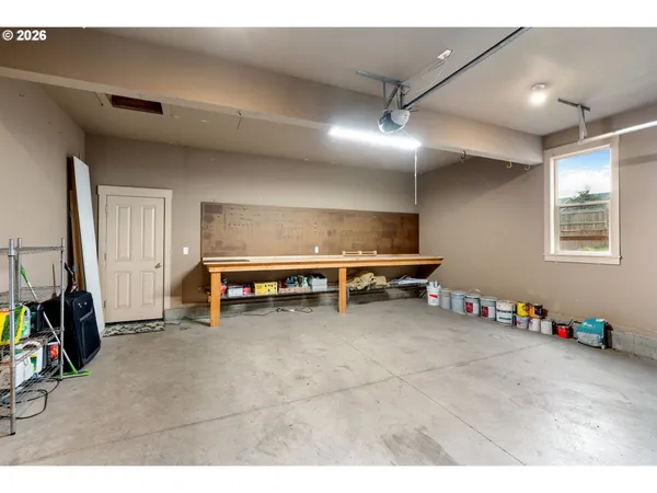 a view of a chairs and table in the backyard