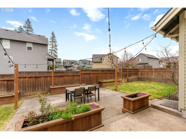 a backyard of a house with table and chairs