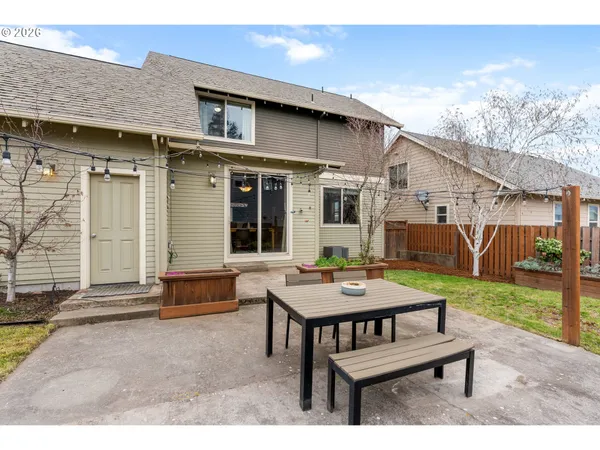 a view of a house with backyard and sitting area
