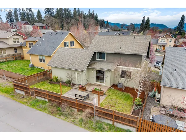 an aerial view of a house with swimming pool and a yard