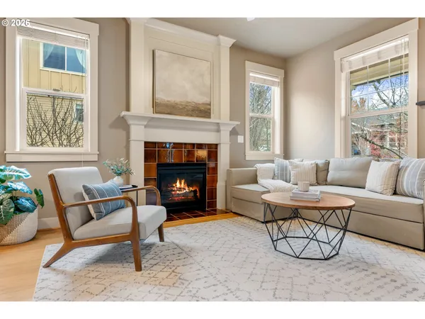 a living room with furniture a window and a fireplace