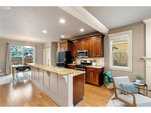 a kitchen that has a table chairs in it and wooden floors