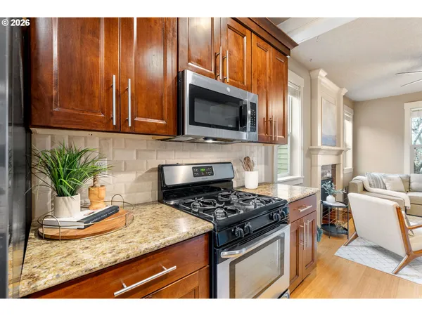 a kitchen with a stove a sink and a microwave