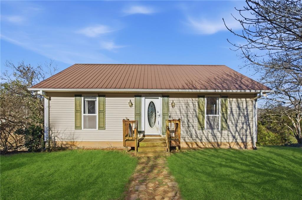 a view of a house with backyard and sitting area