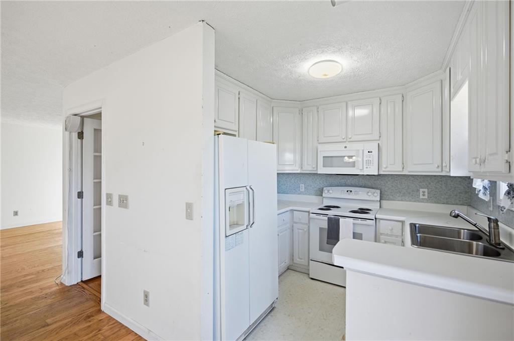 655 Kelley Road Cleveland, GA 30528 - Photo 13 of 41 a kitchen with refrigerator a stove a sink and cabinets