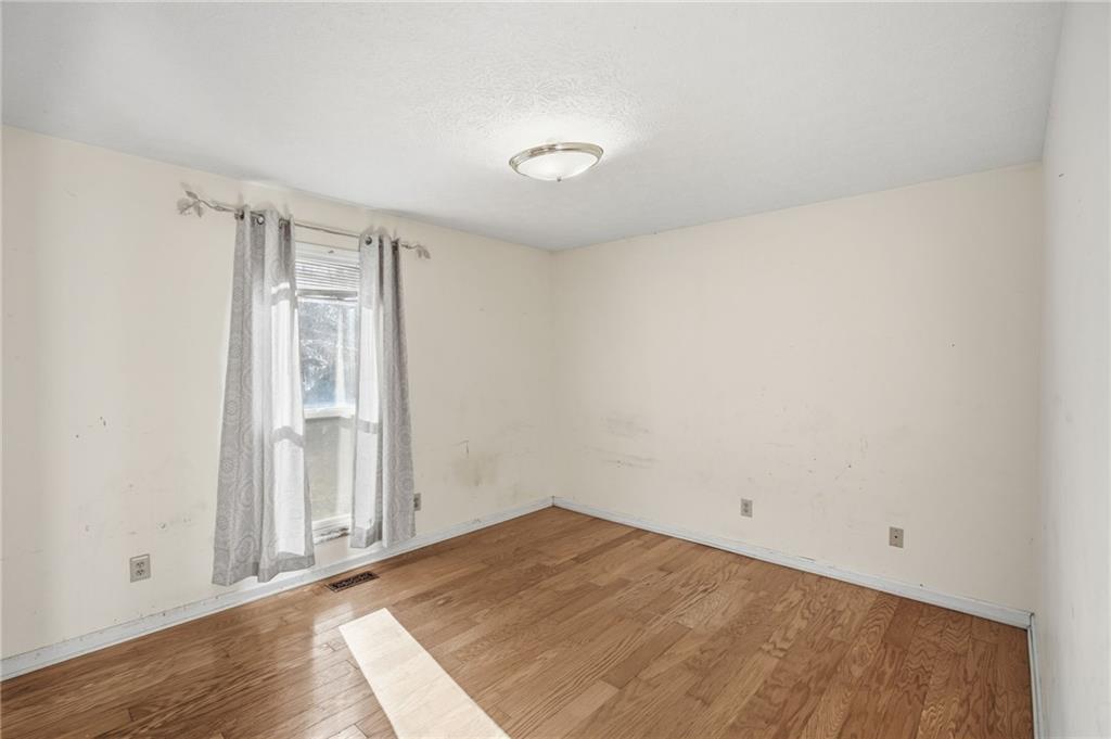655 Kelley Road Cleveland, GA 30528 - Photo 20 of 41 an empty room with wooden floor and windows