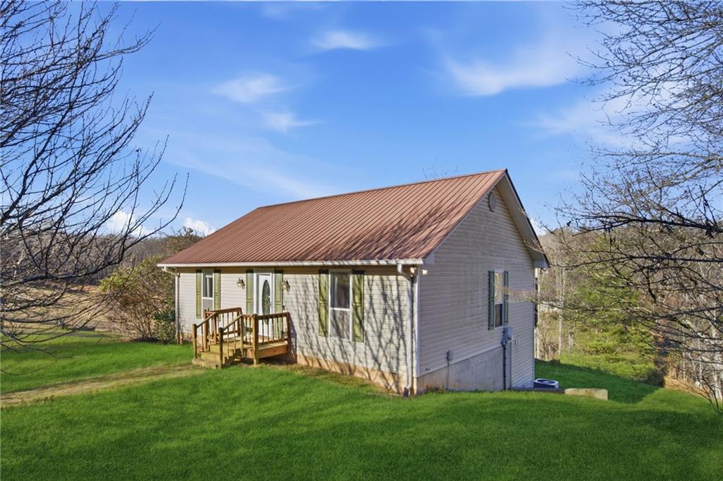 655 Kelley Road Cleveland, GA 30528 - Photo 2 of 41 a front view of a house with garden