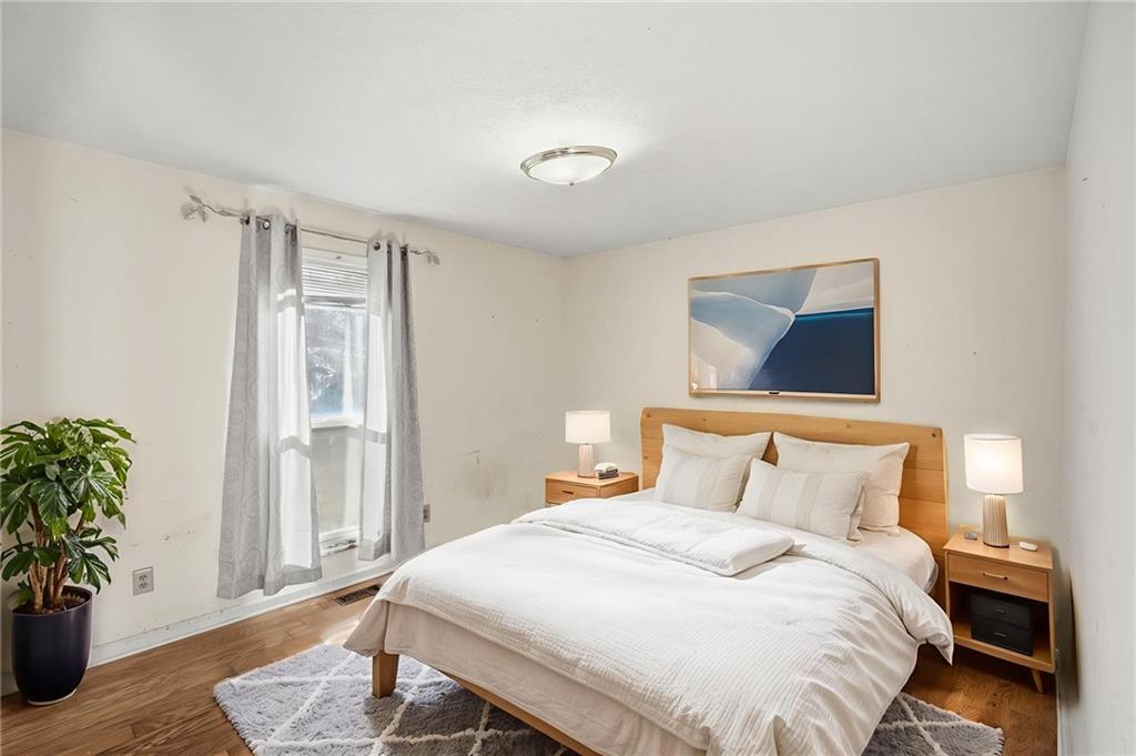 655 Kelley Road Cleveland, GA 30528 - Photo 22 of 41 a bedroom with a bed and a potted plant