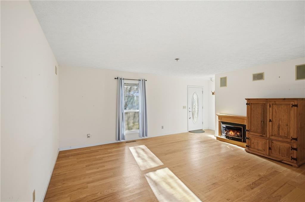 655 Kelley Road Cleveland, GA 30528 - Photo 6 of 41 a view of empty room with furniture and a fireplace