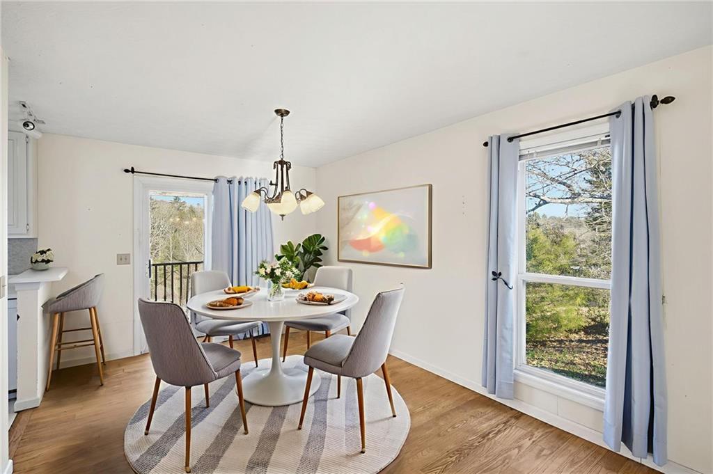 655 Kelley Road Cleveland, GA 30528 - Photo 10 of 41 a dining room with furniture a chandelier and wooden floor