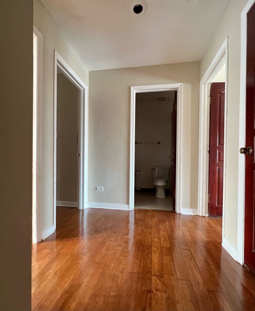 2131 South Archer Avenue, Unit 306 Chicago, IL 60616 - Photo 11 of 15 a view of a room with wooden floor and a bathroom