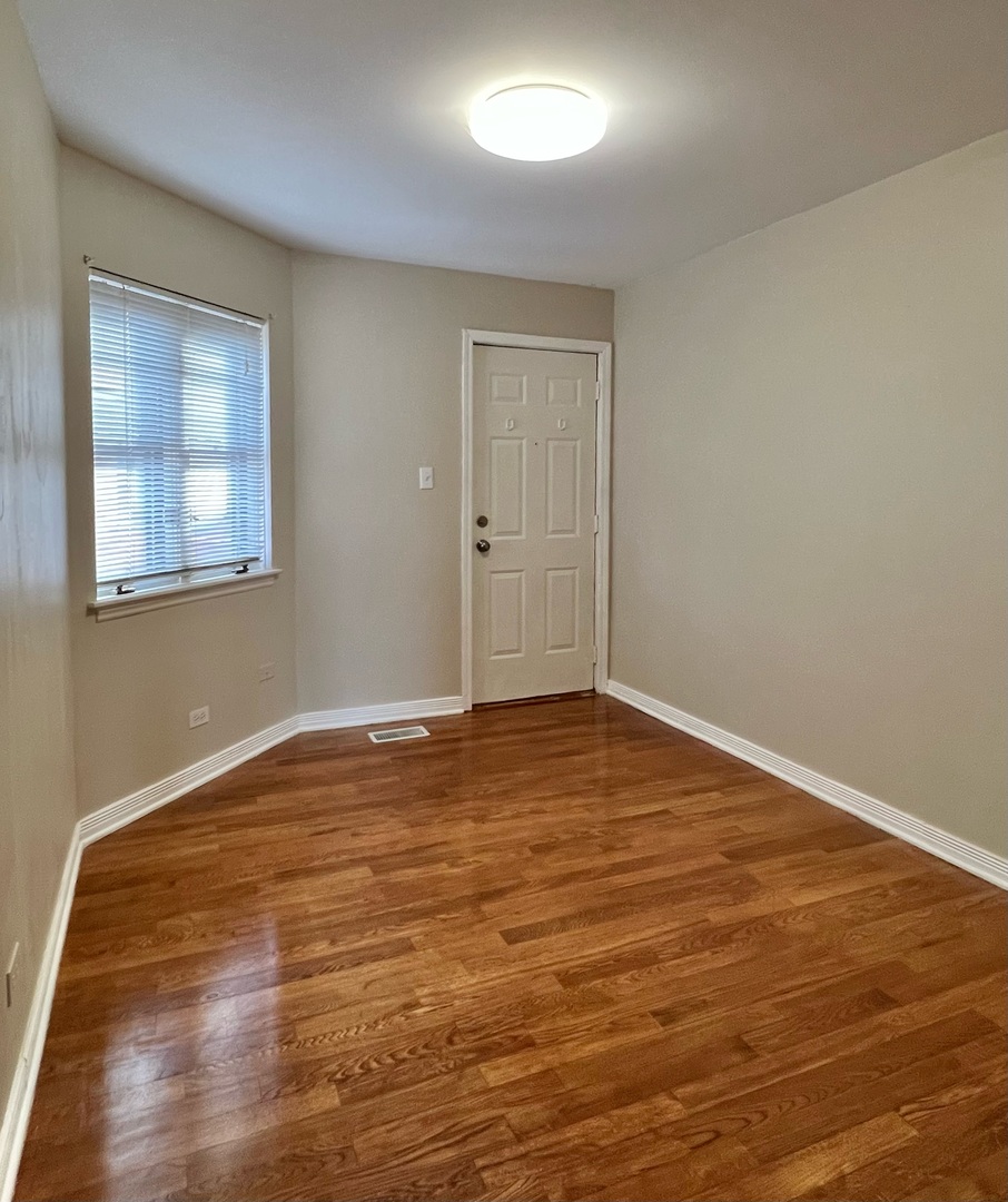 2131 South Archer Avenue, Unit 306 Chicago, IL 60616 - Photo 14 of 15 a view of an empty room and wooden floor
