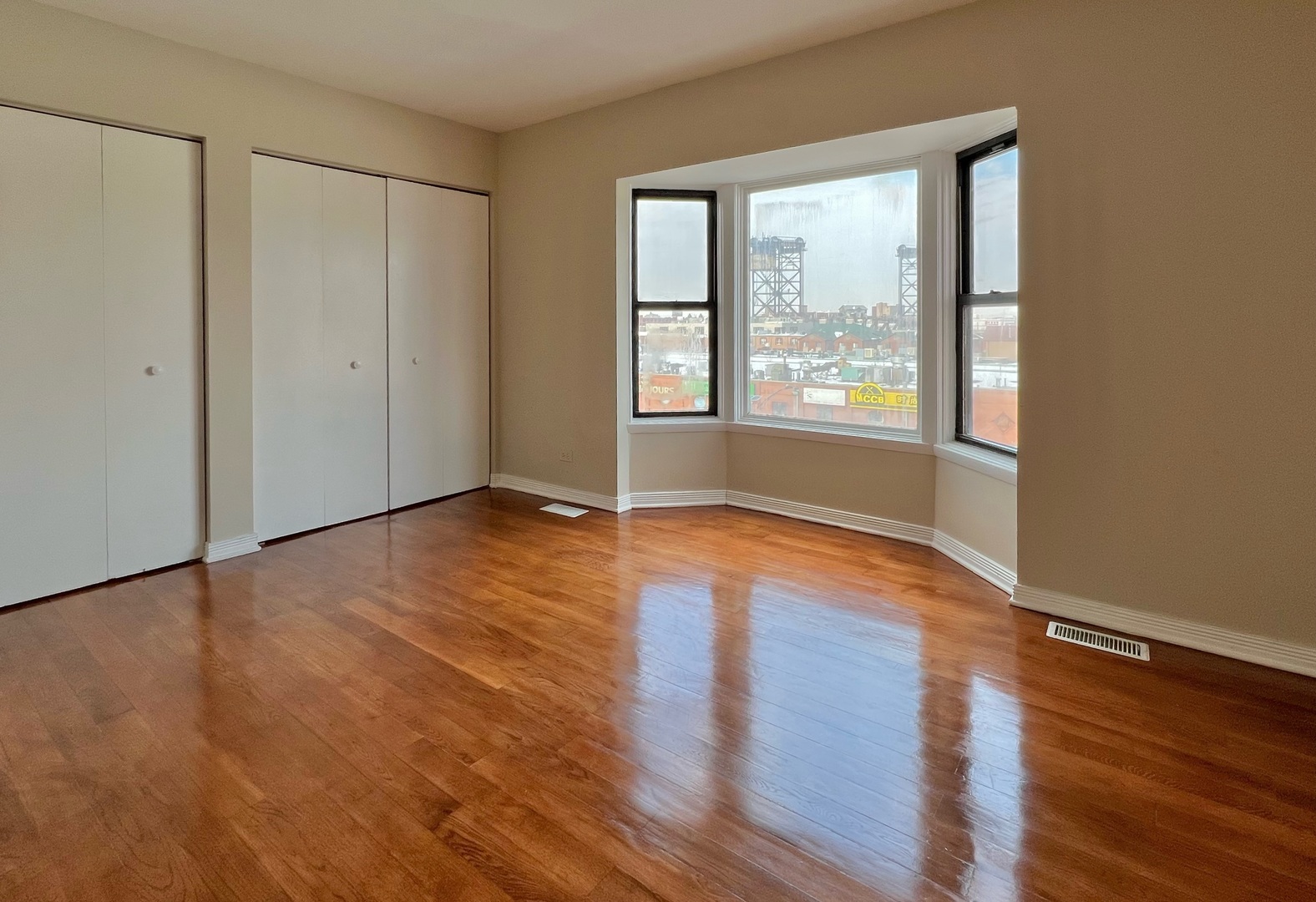 2131 South Archer Avenue, Unit 306 Chicago, IL 60616 - Photo 6 of 15 a view of an empty room with wooden floor and a window