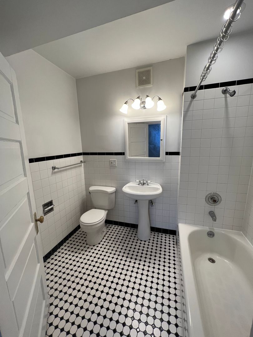 Undisclosed Address Chicago, IL 60613 - Photo 11 of 12 a bathroom with a toilet a sink and a shower