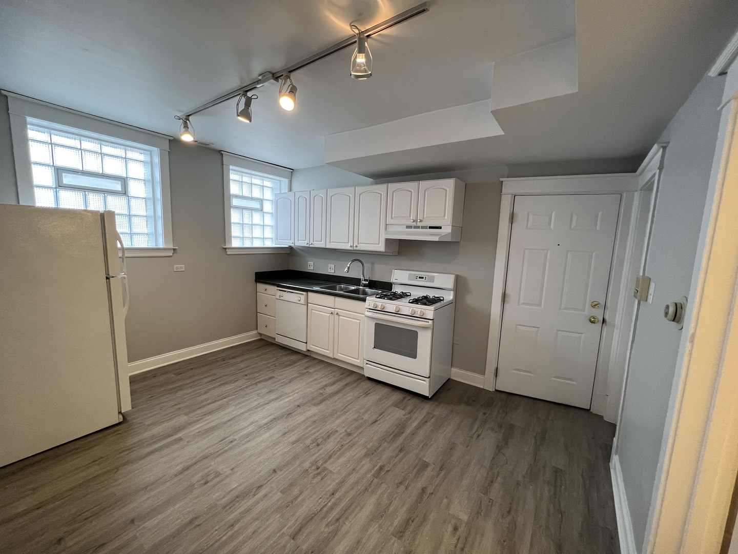 Undisclosed Address Chicago, IL 60613 - Photo 6 of 12 a kitchen with granite countertop white cabinets and white appliances