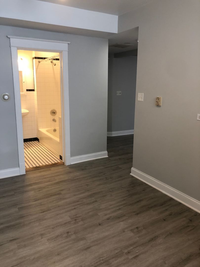Undisclosed Address Chicago, IL 60613 - Photo 9 of 12 a view of a room with wooden floor and a window