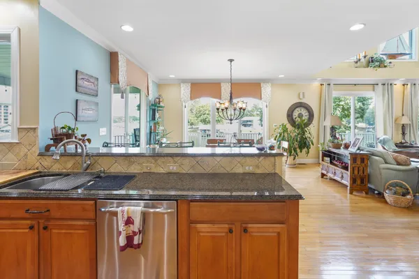 a kitchen with stainless steel appliances granite countertop a refrigerator and a sink