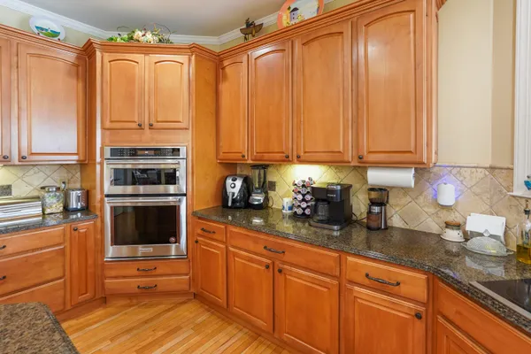 a dining room with furniture a chandelier and wooden floor