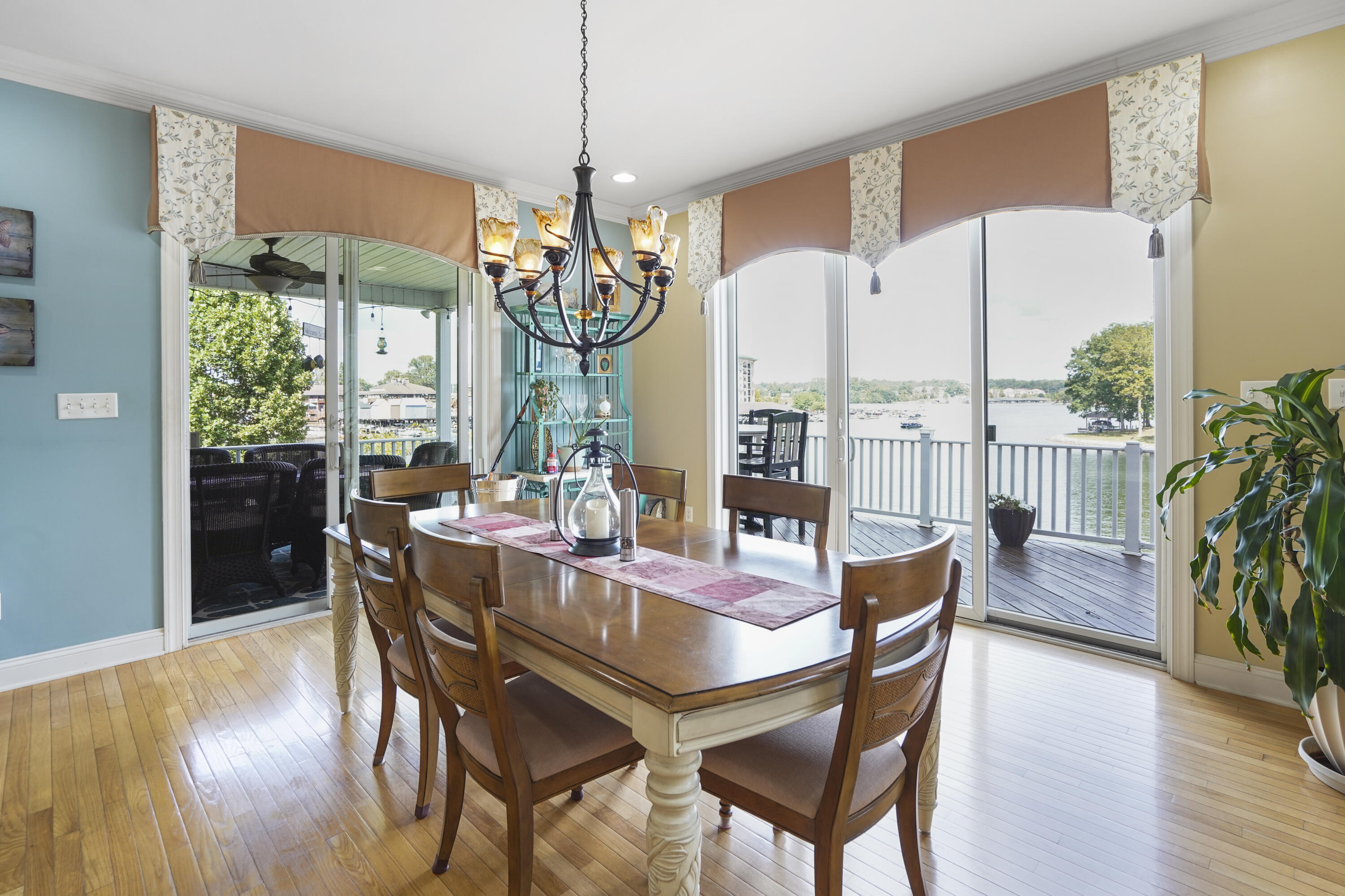 544 Wood Brook Road Moneta, VA 24121 - Photo 16 of 66 a dining room with furniture a chandelier and wooden floor