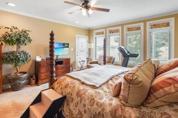 a living room with furniture a bookshelf and a window