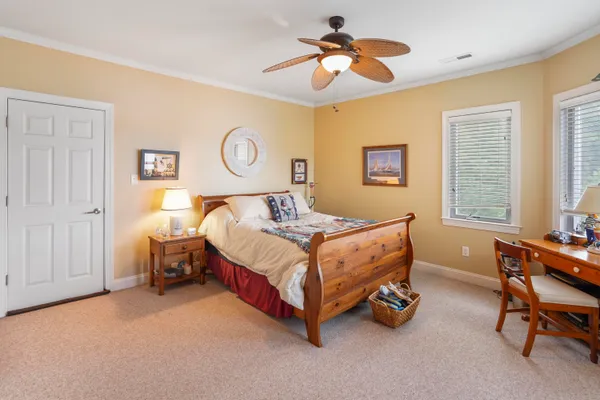 a kitchen with stainless steel appliances granite countertop wooden floors a stove a microwave a dining table and chairs