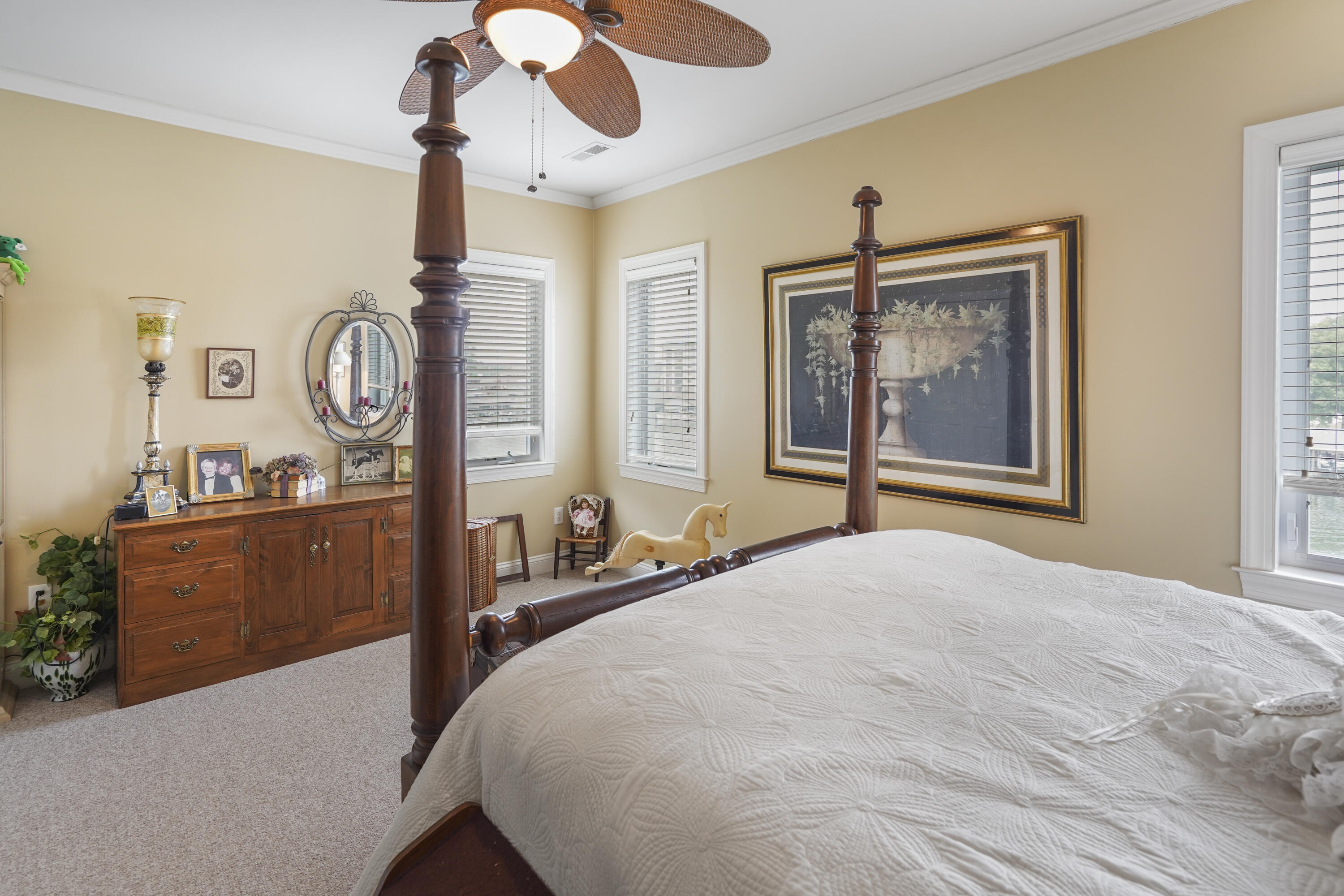 544 Wood Brook Road Moneta, VA 24121 - Photo 39 of 66 a bedroom with a large bed and a chandelier