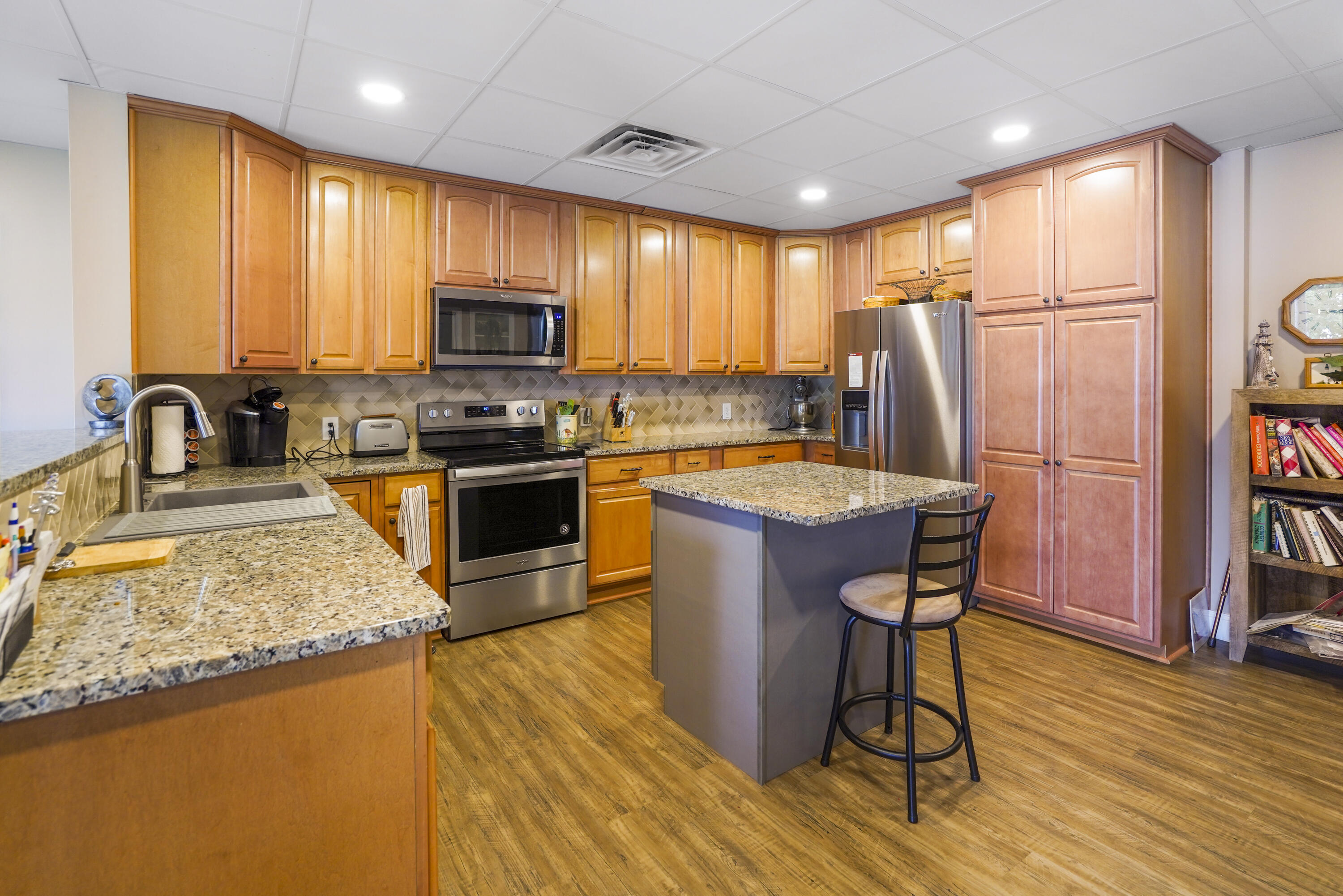 544 Wood Brook Road Moneta, VA 24121 - Photo 42 of 66 a kitchen with stainless steel appliances granite countertop a stove a refrigerator a sink a dining table and chairs with wooden floor