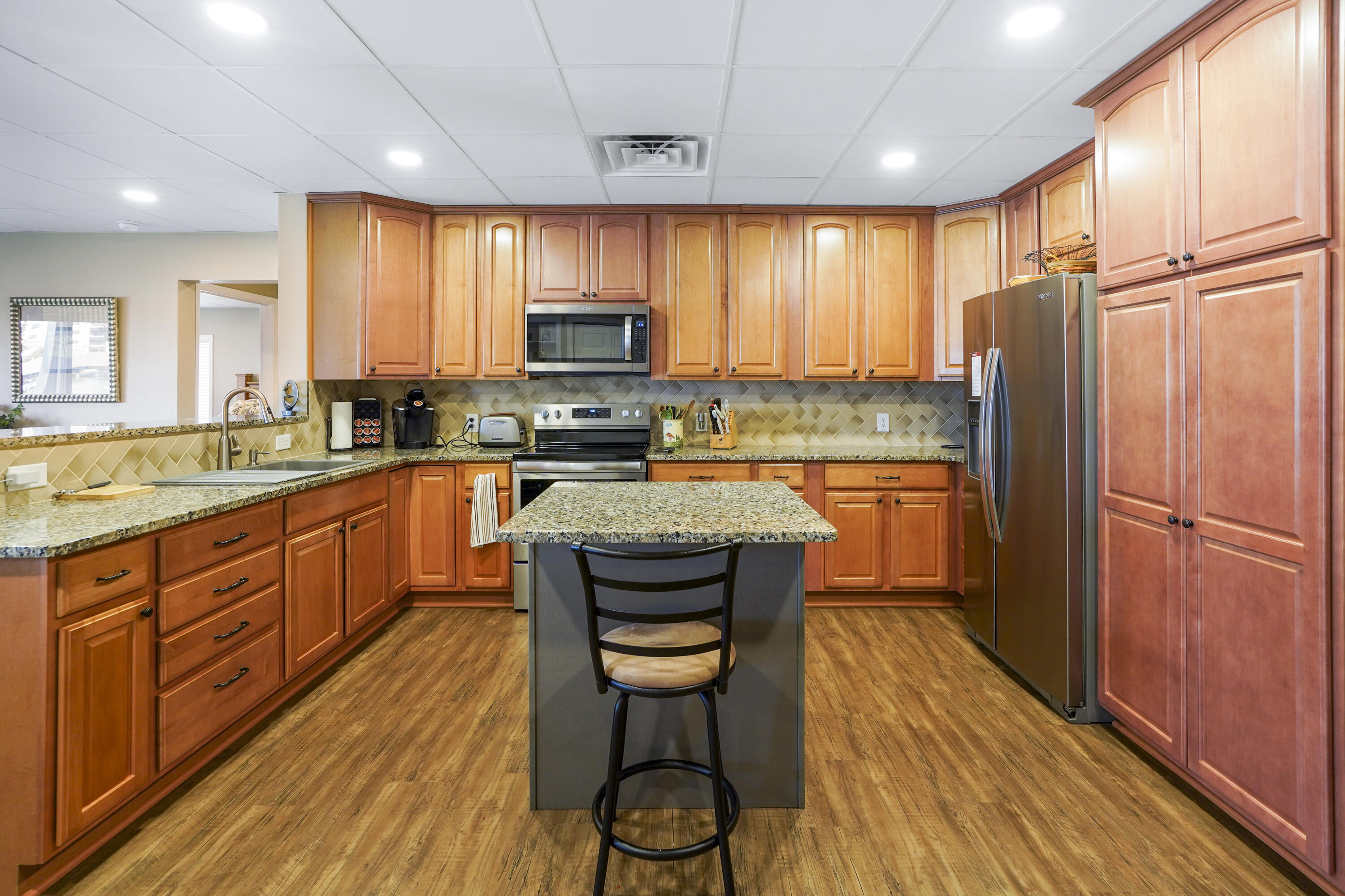 544 Wood Brook Road Moneta, VA 24121 - Photo 43 of 66 a kitchen with stainless steel appliances granite countertop wooden cabinets a sink a stove a refrigerator and island with wooden floor