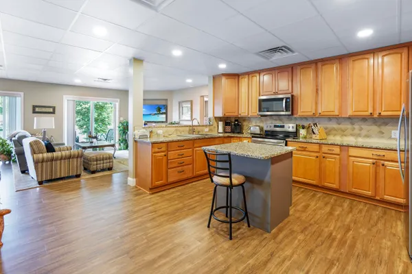 a view of a patio with a table chairs and a backyard