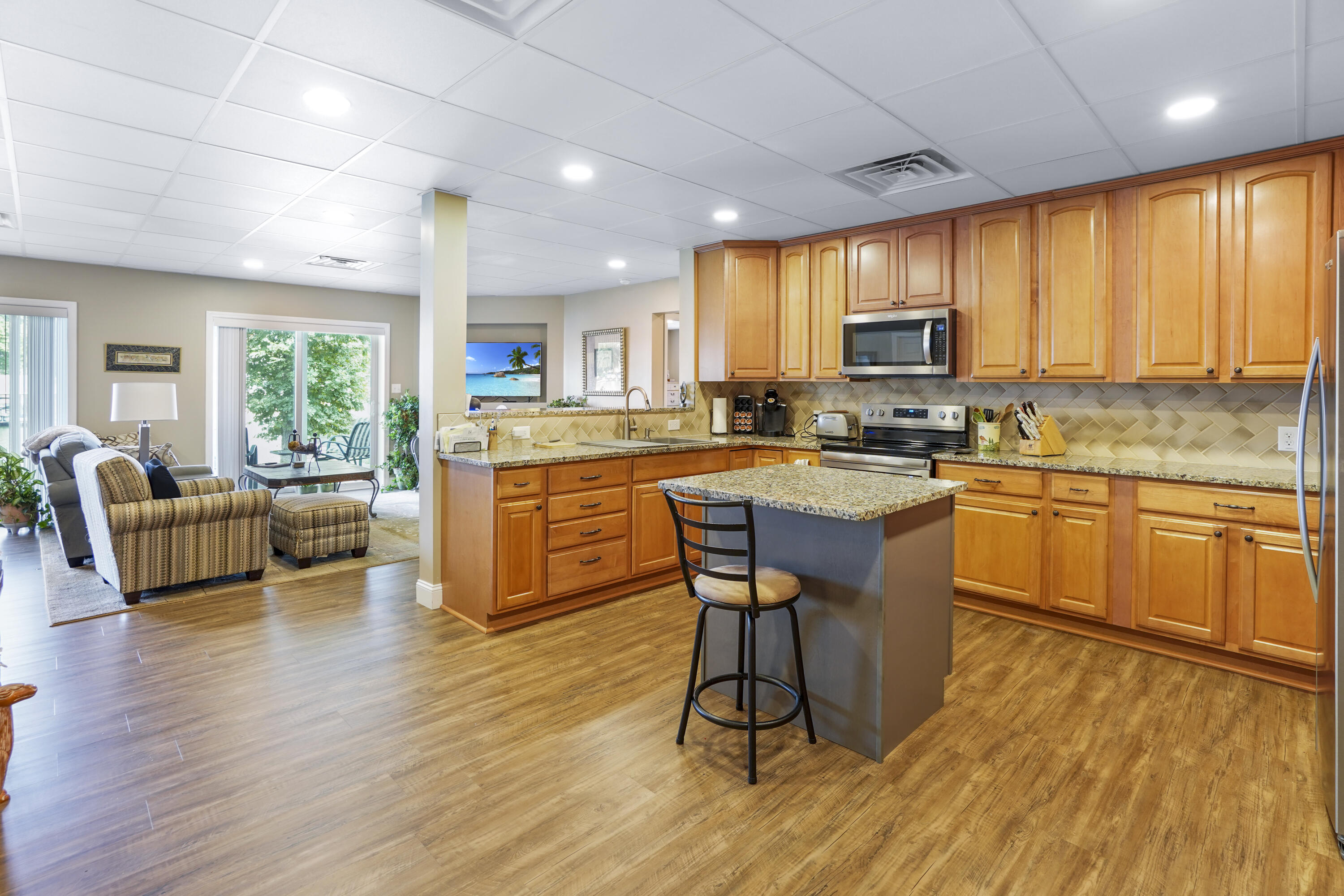 544 Wood Brook Road Moneta, VA 24121 - Photo 44 of 66 a kitchen with stainless steel appliances granite countertop wooden floors a stove a microwave a dining table and chairs