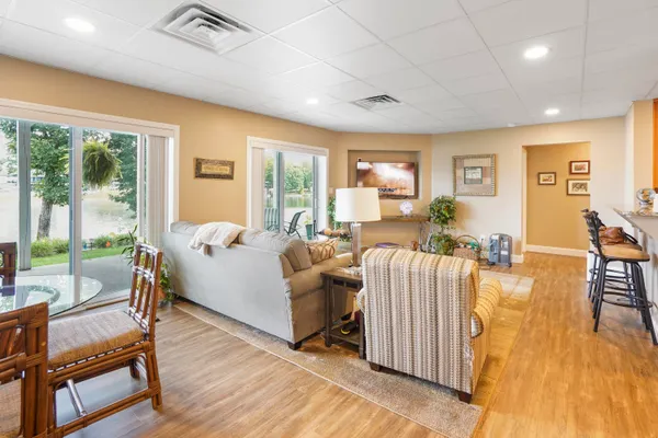 a view of a balcony with wooden floor and outdoor seating