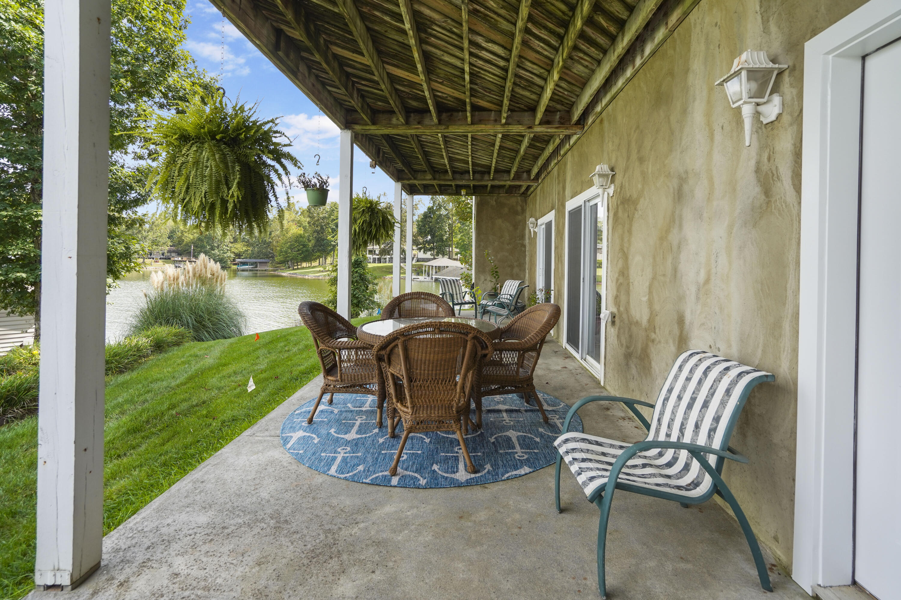 544 Wood Brook Road Moneta, VA 24121 - Photo 55 of 66 a view of a patio with a table chairs and a backyard