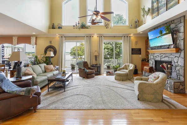 a living room with furniture a fireplace and a chandelier