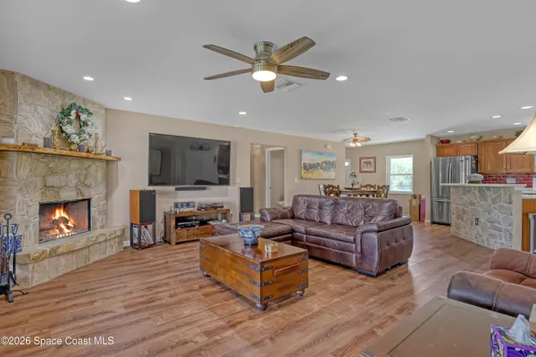 a view of a green field with trees in the background