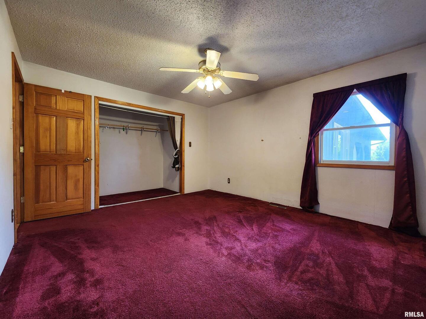 10107 Sugar Creek Road Benton, IL 62812 - Photo 17 of 43 an empty room with windows and closet