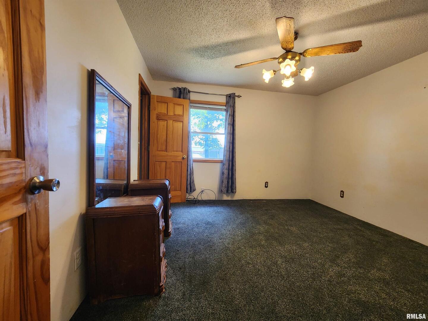 10107 Sugar Creek Road Benton, IL 62812 - Photo 19 of 43 a view of an empty room with window and chandelier fan