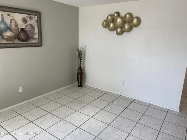 a kitchen with a sink a refrigerator and cabinets