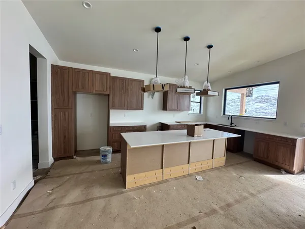 a living room with stainless steel appliances kitchen island granite countertop furniture and a view of living room